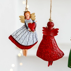 Vintage metal Christmas angel ornaments with white and red dresses for holiday tree decor
