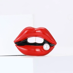 Creative red enamel lips brooch with a single pearl accent on white background