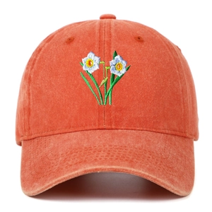 Detail of floral embroidery and washed cotton texture on a retro baseball cap