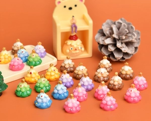 Macro shot of colorful resin mini Christmas candy trees with gold star toppers for DIY crafts