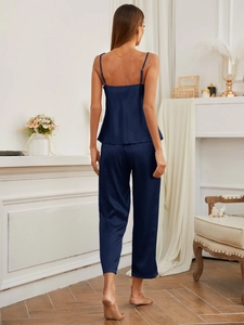 Elegant dark blue satin sleepwear set showing the backless top and silk texture