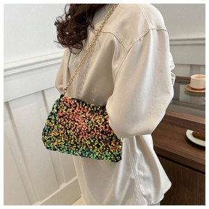 Close-up of sparkling multi-color sequins and metal chain strap on a crossbody bag