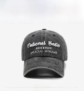 Detail of vintage washed grey baseball cap featuring white 3D embroidery and stitching