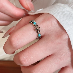 Macro detail of vintage resin ring with turquoise stones and antique silver engraving