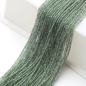 Detail of 2mm dark green faceted glass beads on strings for DIY jewelry making