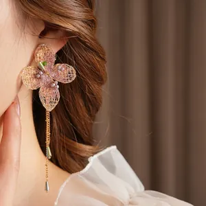 Vintage style hand-woven flower tassel earrings with purple beads in a palace aesthetic