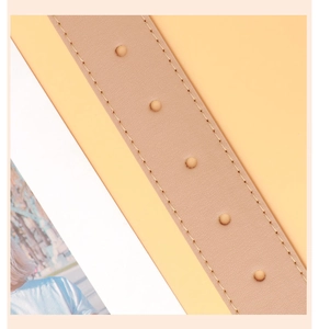 Close-up of pink PU leather belt featuring precise stitching and silver round metal studs