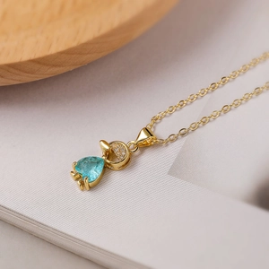 Macro view of 18K gold plated necklace featuring a heart-shaped blue zircon pendant