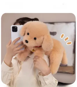 Close-up of plush Labrador dog toy with soft beige fur and a red collar with a golden bell