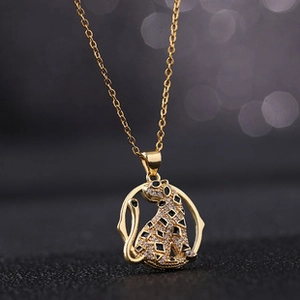 Macro shot of gold leopard pendant with zircon pave setting on a refined necklace