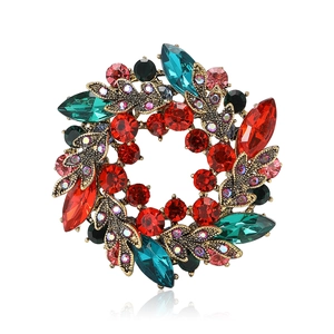 Elegant wreath flower brooch with red and green rhinestones on bronze metal base