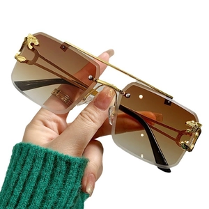 Frameless brown gradient sunglasses with golden cheetah head metal decoration on temples