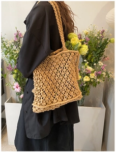 Detail of khaki macrame woven bag with floral decor and thick hand-braided shoulder strap