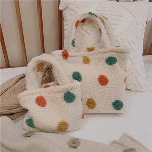 Detailed set of two fuzzy polka dot tote bags in cream with green and orange spots