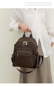 Detailed view of the brown pattern backpack with golden zippers and multiple pockets