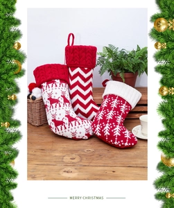 Close-up of large knitted Christmas stockings with elk patterns on a wooden table