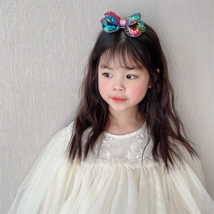 Detailed close-up of a sparkling double-layered sequin butterfly hair clip for girls