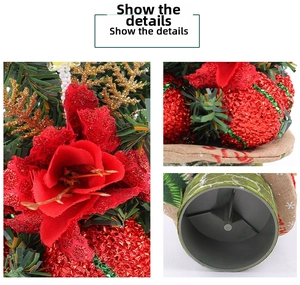 Detailed view of artificial pine needles, red glitter flowers, and a burlap snowflake base