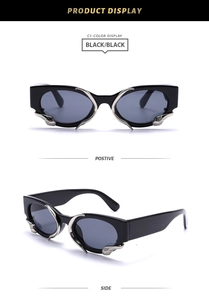 Detail view of black Y2K sunglasses with silver liquid metal snake design and thick frame
