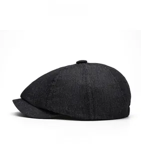 Side view of black denim newsboy cap showing classic eight-panel crown and twill texture