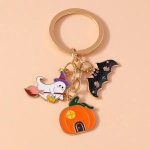 Detail of Halloween ghost keychain with witch hat, black bat and orange pumpkin charms