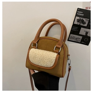 Detail of retro brown suede handbag with cream sherpa trim and adjustable shoulder strap