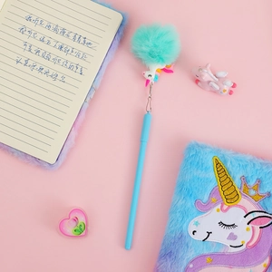 Detail of unicorn gel pen with a turquoise fluffy pompom and rainbow charm attachment