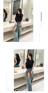 Brown checkered handbag with leather trim and wrist strap in a modern bathroom setting