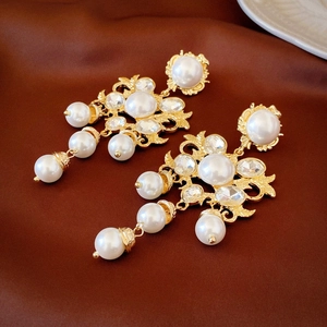 Vintage court style flower earrings with pearls and crystals on brown silk background