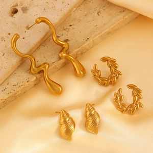 Close-up of gold stainless steel irregular liquid metal and laurel leaf hoop earrings