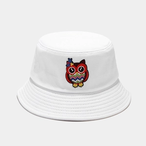 Close-up detail of the colorful cartoon owl embroidery on a white cotton bucket hat