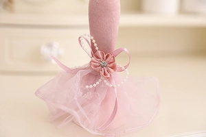 Detailed view of pink lace mannequin stand with pearls and ribbon for jewelry display