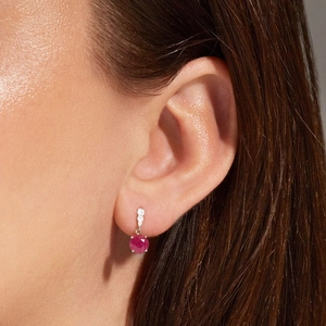 Detail shot of 925 silver earring featuring a red gemstone with white diamond accents