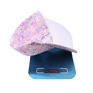 Lightweight floral print cotton baseball cap for kids weighing 59g on a digital scale