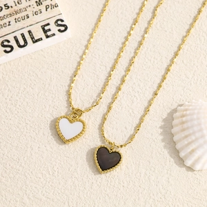Elegant gold heart necklaces with white shell and black enamel pendants on a minimalist chain