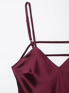 Close-up of wine red satin midi dress featuring a V-neckline and delicate strap details