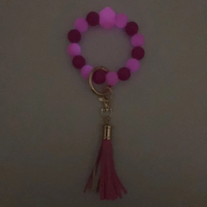 Portachiavi con perle di silicone fosforescenti, nappina rosa e chiusura in metallo dorato