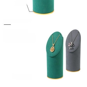 Macro detail of velvet necklace stands in green and grey with gold aluminum alloy bases