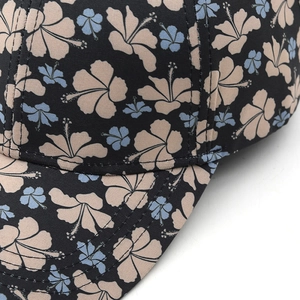 Macro detail of tropical hibiscus floral print and reinforced stitching on baseball cap
