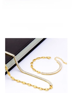 Detail of gold titanium jewelry set with coffee bean links and rectangular zircon stones