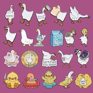 Detailed close-up of funny enamel pins featuring cartoon ducks and geese with humor slogans