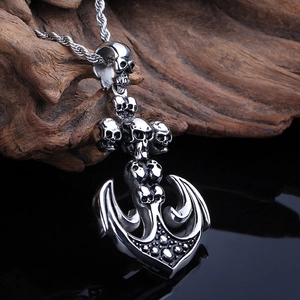 Detailed macro shot of a punk skull and anchor pendant showing stainless steel engraving