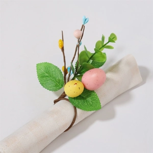 Detail of Easter napkin ring with colorful eggs and eucalyptus leaves on linen napkin