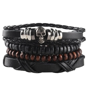 Close-up of multilayer leather bracelet with skull charm and wooden beads on white background