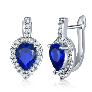 Detail of luxury teardrop earrings featuring blue pear-cut stones and pavé set crystals