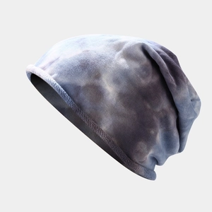 Macro view of blue-purple tie-dye knit beanie showing detailed texture and slouchy fit