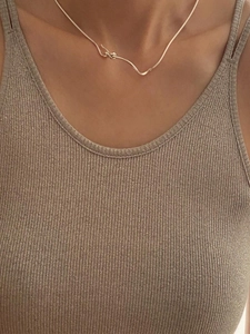 Minimalist 925 sterling silver knot choker necklace in gold finish worn by a model