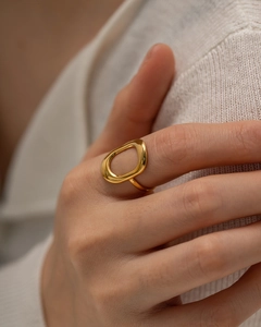 Close-up of 18k gold plated stainless steel hollow geometric ring on a white knit sleeve