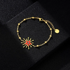 Macro shot of gold stainless steel beaded chain with red enamel evil eye star charm