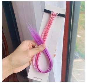 Detail of pink to purple gradient braided hair extension with elastic hair tie